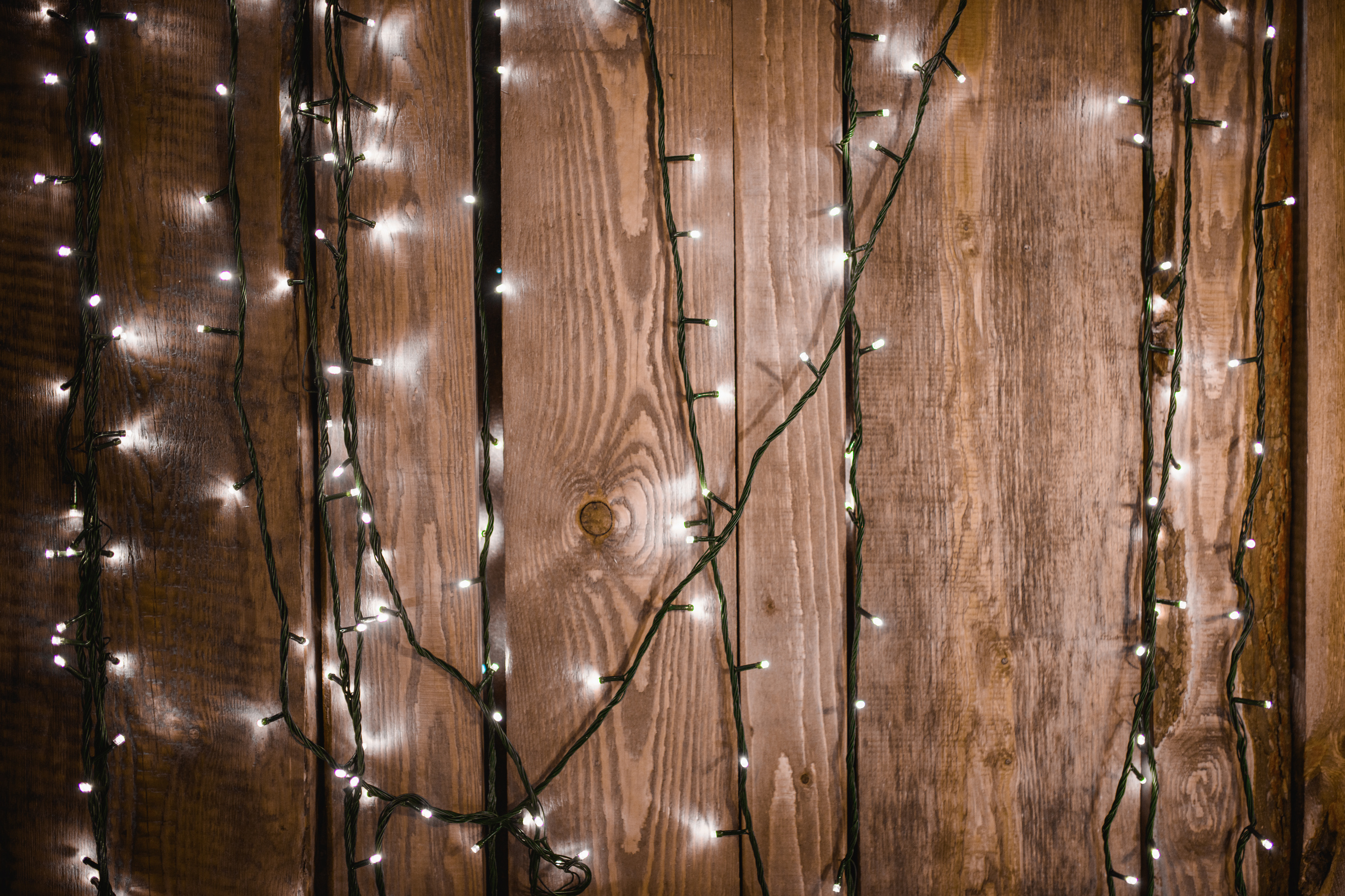 Light Garlands on Wooden Background. 